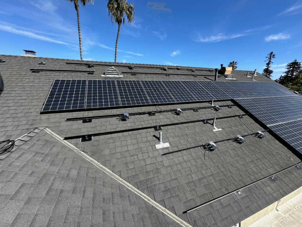 solar panels being installed on asphalt roof