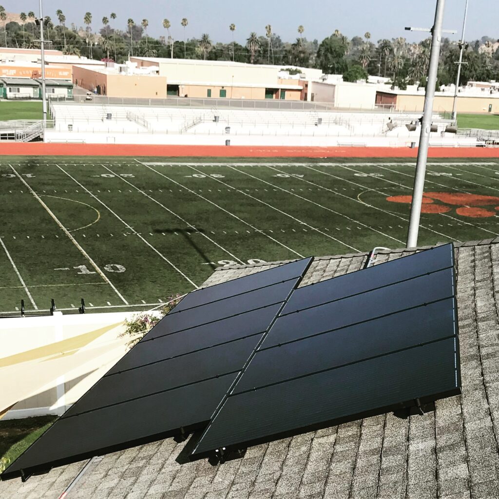 Rooftop solar install overlooking football field